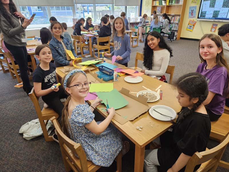 HS students and Mills Pond students at a table